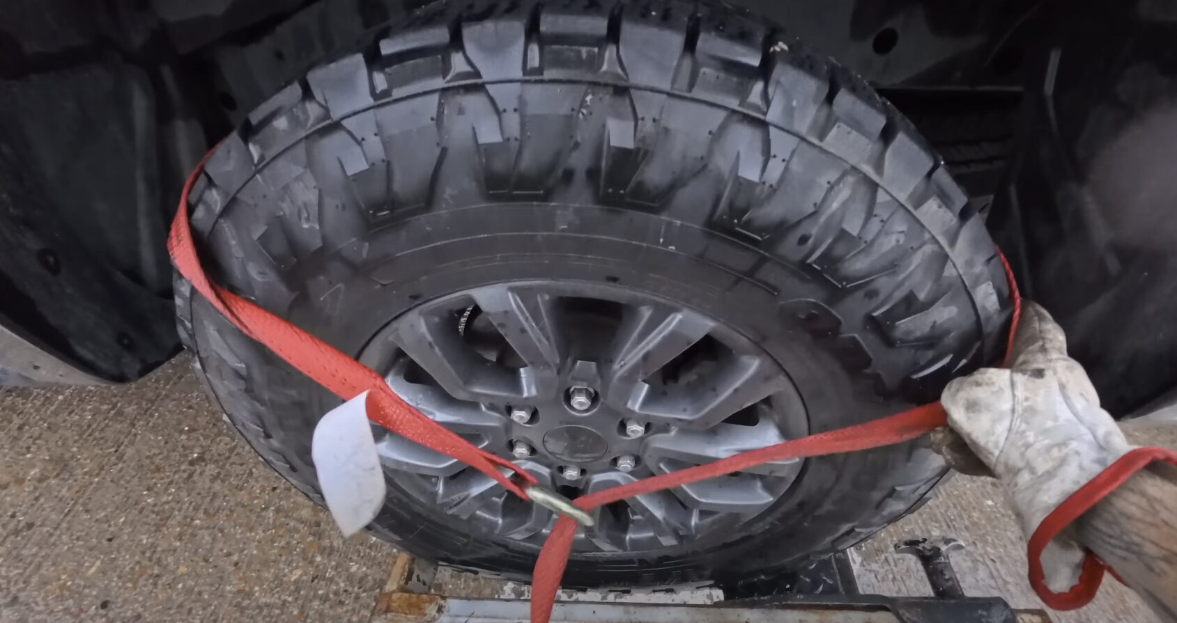 24/7 Roadside Assistance Service in Friendswood, TX Roadside assistance - tire being secured with red straps
